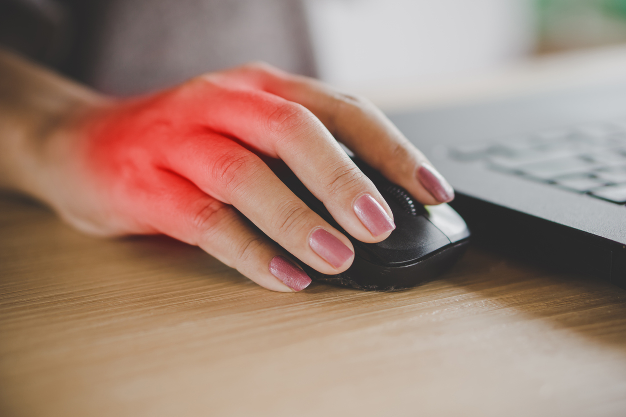 business woman hand pain caused by an excessive use of mouse